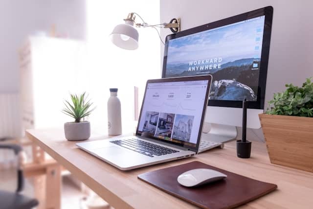 Two monitors Displaying A Website