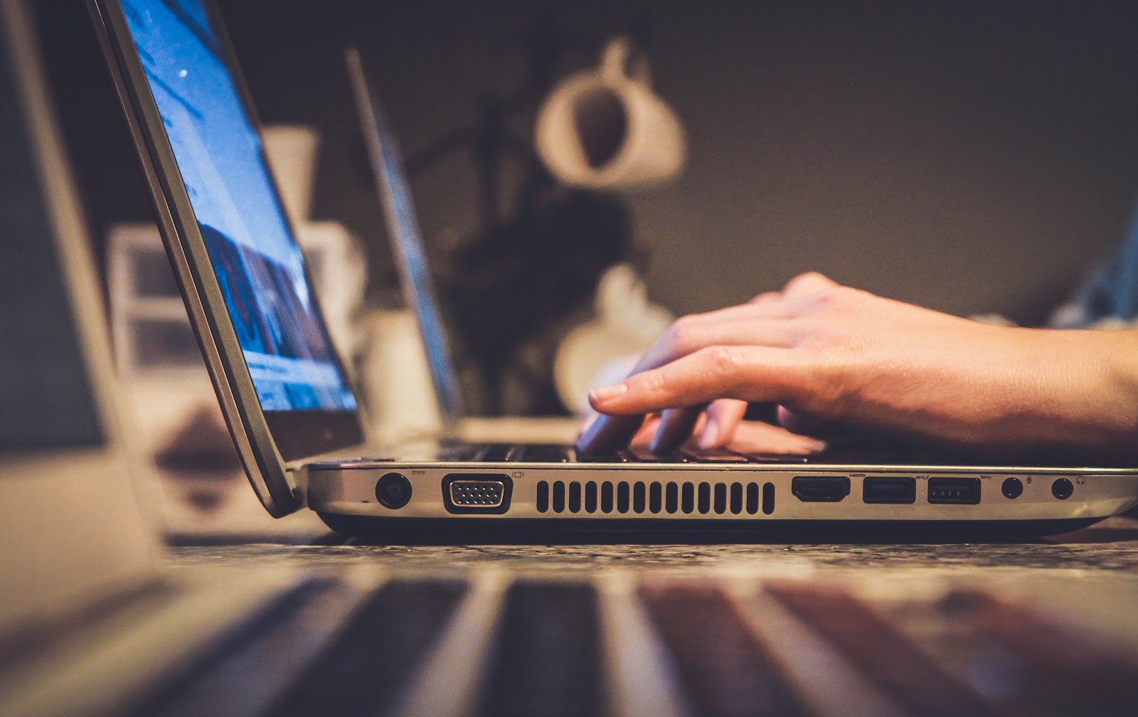 A person typing on a laptop 